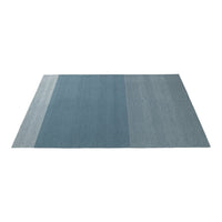 Blue gradient rug with subtle texture, featuring a blend of light and dark blue tones in a striped pattern.