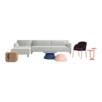Modern gray sectional sofa with colorful accent pieces in pink, purple, and orange, featuring smooth and geometric shapes.