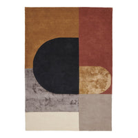 Modern geometric rug featuring warm brown, deep black, muted gray, and rich red tones with abstract shapes.