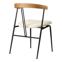 Cream upholstered chair with a natural wood backrest and black metal legs, featuring a minimalist design.