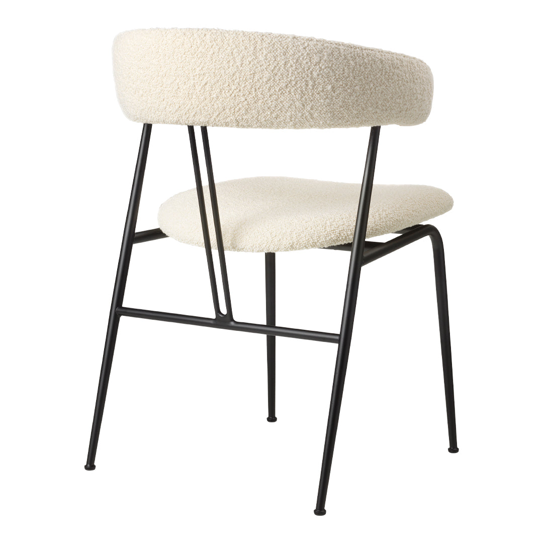 Cream upholstered chair with textured fabric and sleek black metal legs. Modern and stylish design for any space.