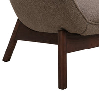 Brown textured upholstery with dark wood legs, showcasing a minimalist design and cozy aesthetic.