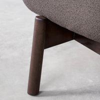 Brown textured upholstery with dark wood legs, showcasing a minimalist design and subtle, elegant patterns.
