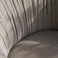 Soft beige upholstery with elegant vertical pleats and a smooth, rounded cushion in subtle, neutral tones.