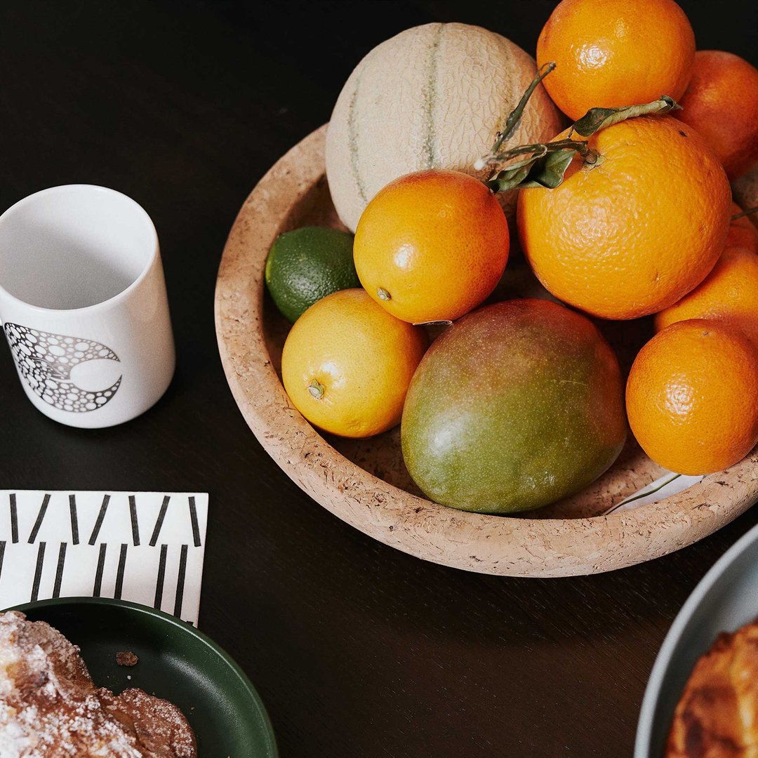 "Colorful assortment of fresh fruits in a natural bowl, showcasing vibrant oranges, yellows, and greens."