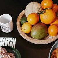 "Colorful assortment of fresh fruits in a natural bowl, showcasing vibrant oranges, yellows, and greens."