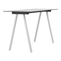 Modern black tabletop with sleek white legs, featuring a minimalist design and clean lines. Ideal for contemporary spaces.
