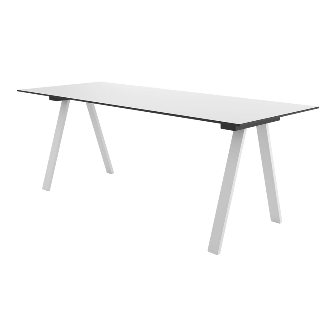 Modern white desk with sleek, minimalist design featuring a solid, smooth surface and angular white legs.