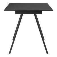 Sleek black table with a minimalist design and smooth, solid surface, featuring angled legs for modern aesthetics.