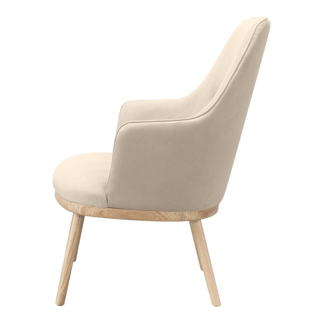 Cream upholstered chair with smooth fabric and light wooden legs, showcasing a minimalist design.
