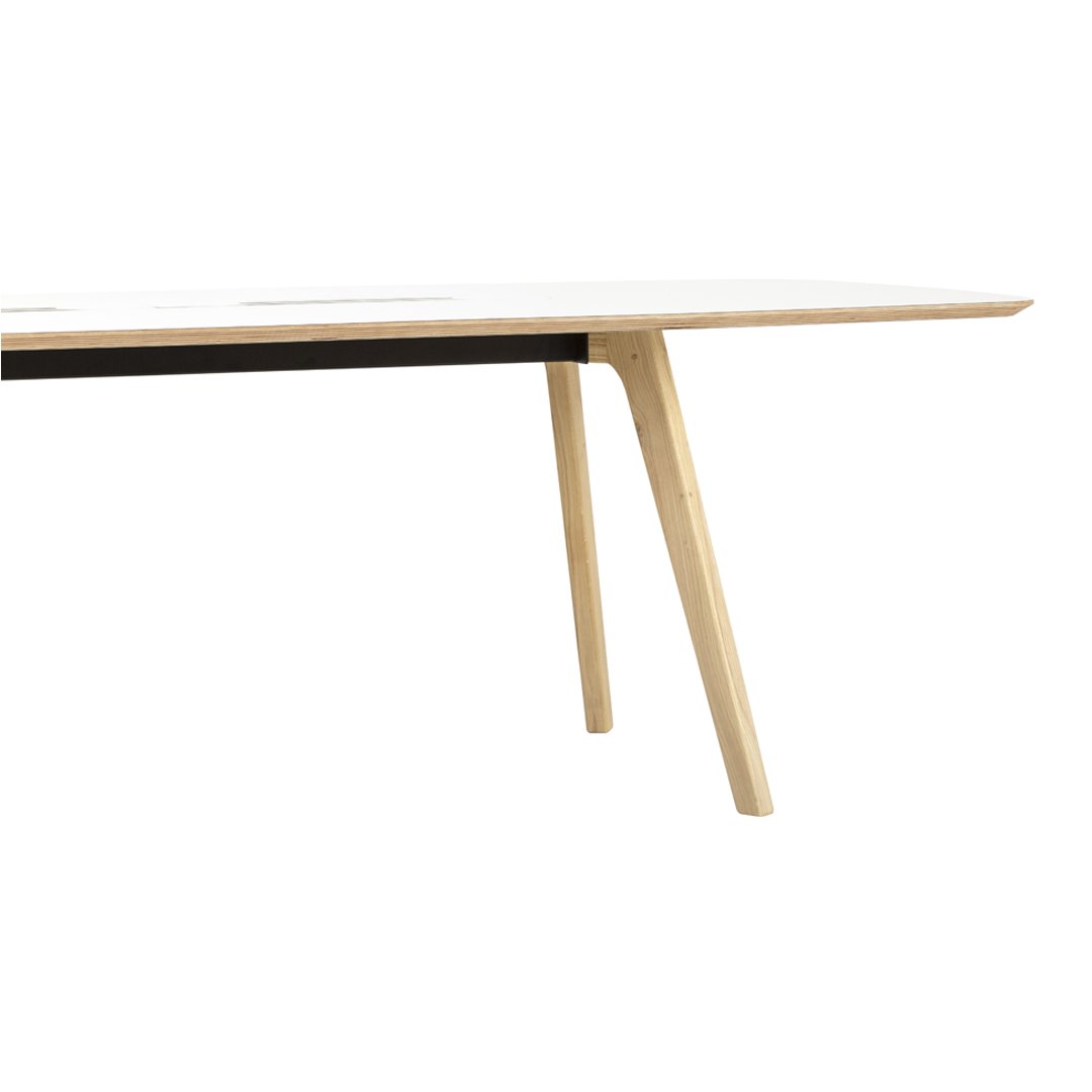 Light wood table with a sleek white top and contrasting black stripe, featuring minimalist, modern design.