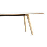 Light wood table with a sleek white top and contrasting black stripe, featuring minimalist, modern design.