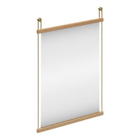 Neutral-colored wall mirror with a simple, modern wooden frame and brass accents, perfect for any decor style.