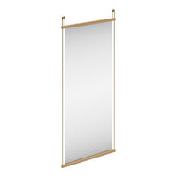 Minimalist vertical mirror with a natural wood frame and sleek gold accents, featuring a reflective surface.