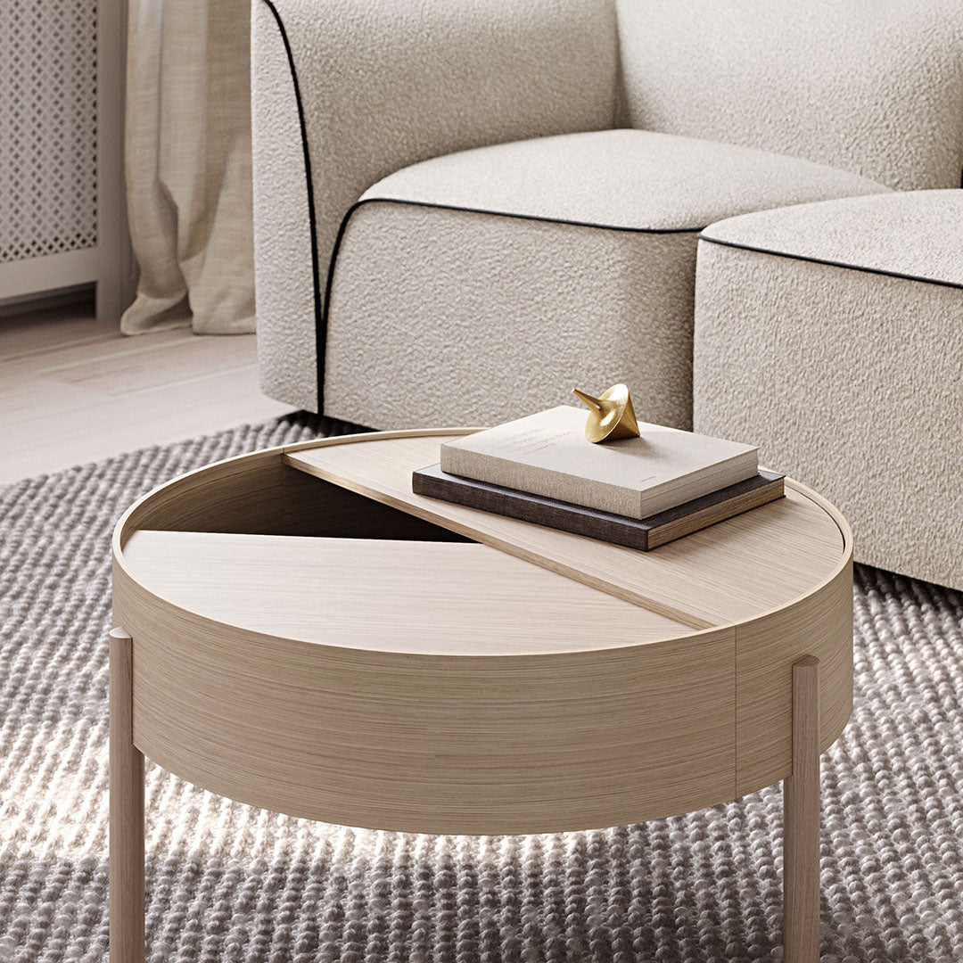 "Round wooden coffee table featuring light wood finish with sleek, modern design and geometric patterns."