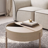 "Round wooden coffee table featuring light wood finish with sleek, modern design and geometric patterns."