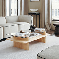 Light wood coffee table with a glass top, complemented by neutral tones and subtle textures in a modern living room setting.