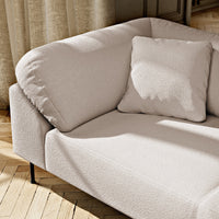 Light beige sofa with a smooth texture and matching cushion, featuring minimalistic design and soft, modern aesthetic.