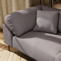 Gray textured fabric sofa with subtle patterns and a matching cushion, creating an elegant, cozy look.