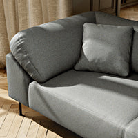 Gray fabric sofa with smooth texture and a matching square cushion, perfect for modern living spaces.