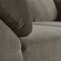 Soft brown fabric sofa with plush, textured cushions in a neutral color palette. Ideal for modern living spaces.