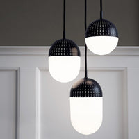 Black and white pendant lamps with dot patterns and smooth glass globes, offering a modern, minimalist aesthetic.