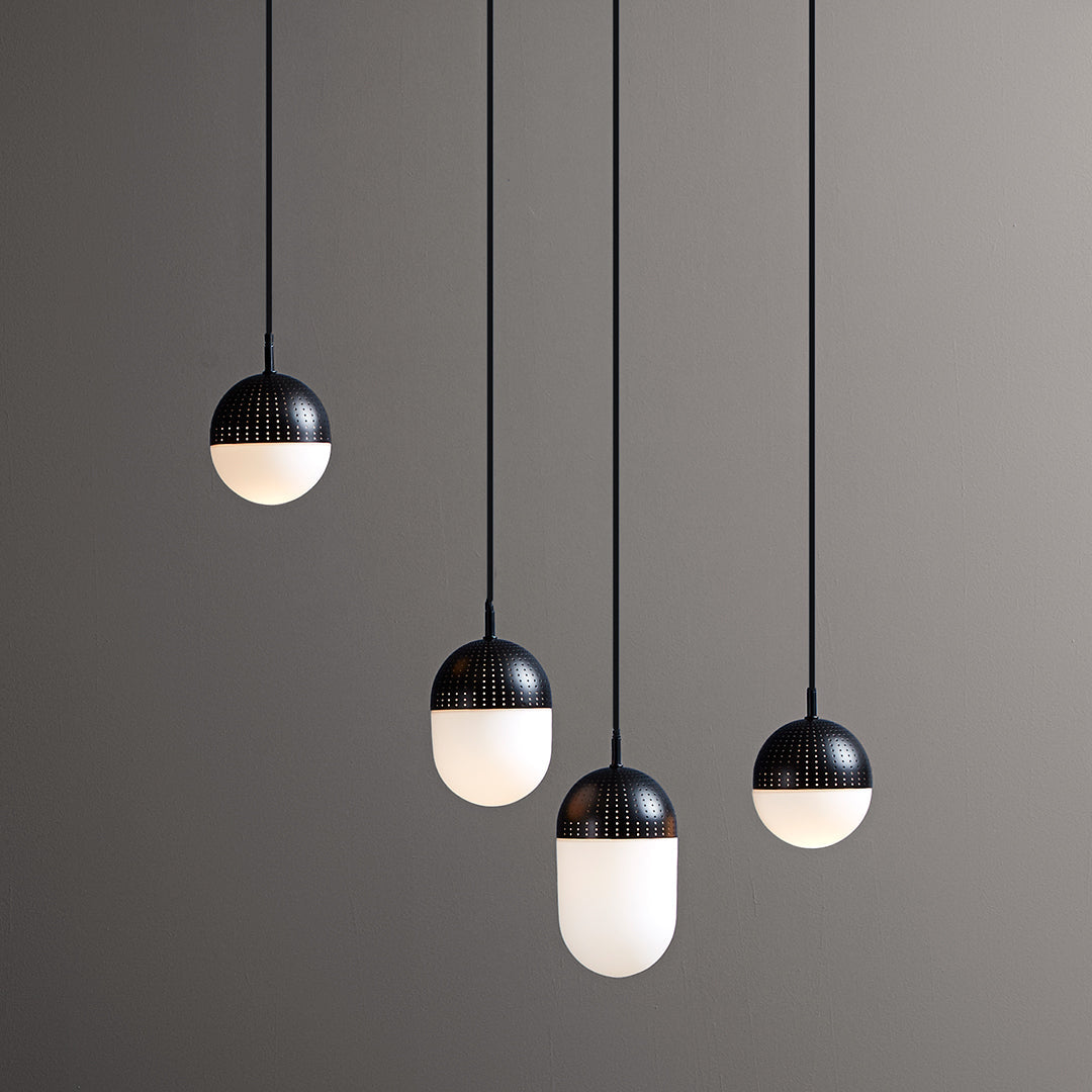 Modern pendant lights featuring a sleek black and white color scheme with smooth, rounded shapes.