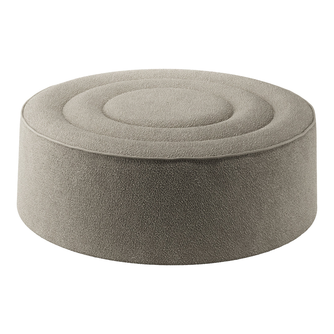 Round gray pouf with a textured, circular pattern on the top, perfect for modern decor.