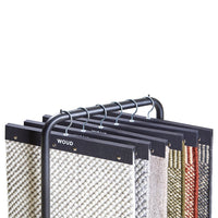 Colorful woven fabric samples featuring geometric and textured patterns on a metal display rack.