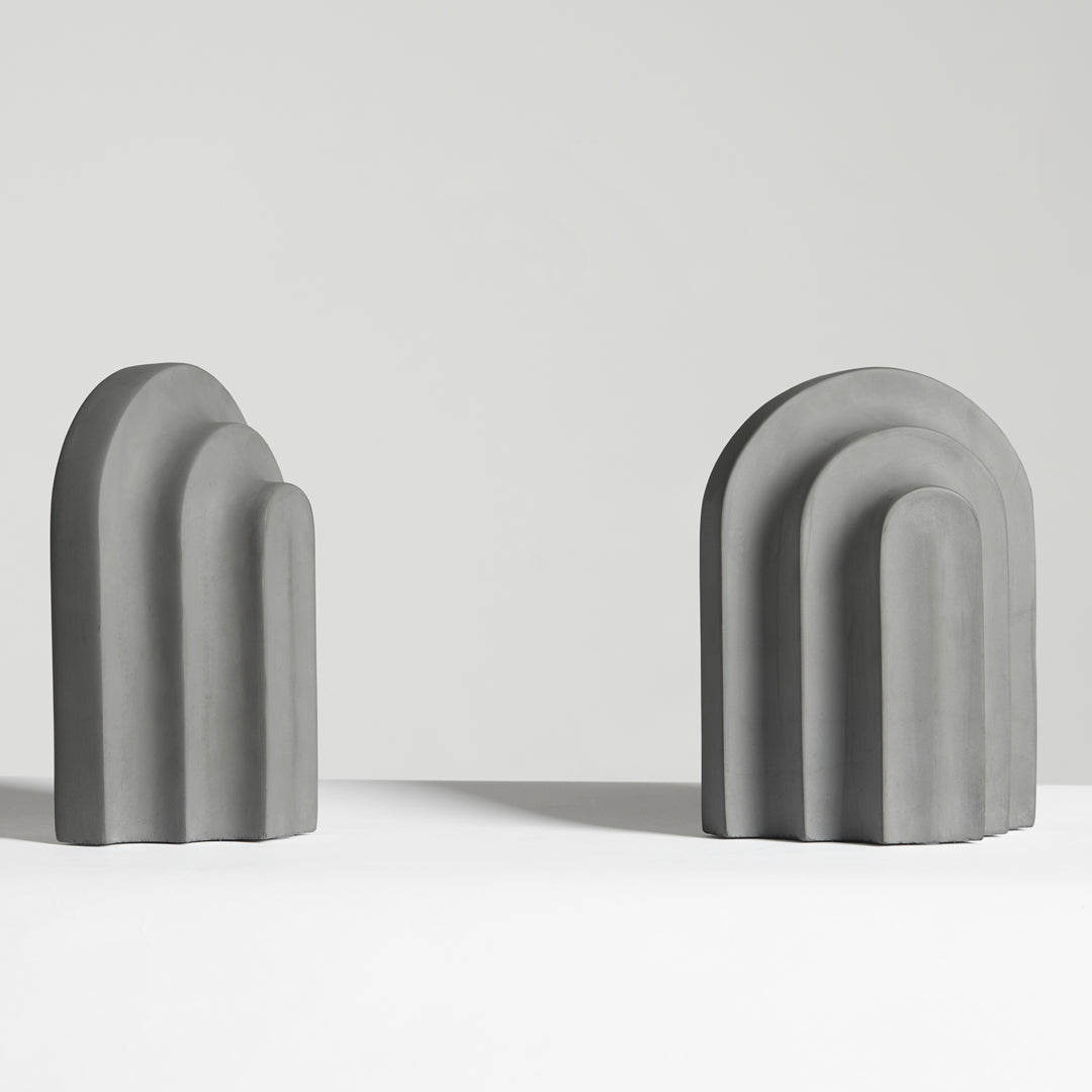 Gray geometric decorative shapes with curved arches, showcasing a modern minimalist design.