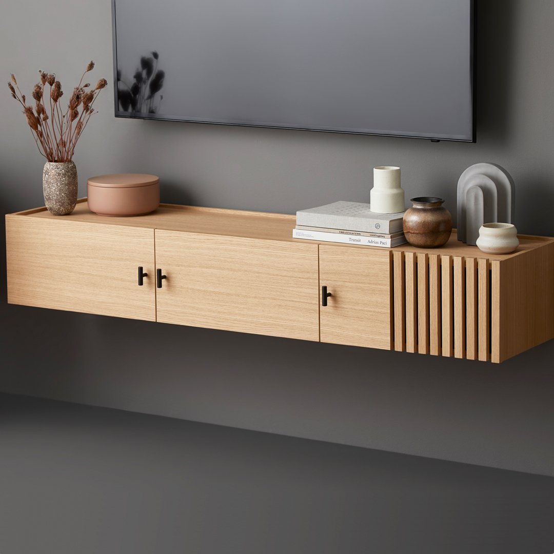 Light wood floating shelf with slatted design; neutral decor accents in soft beige and earthy tones.