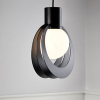 Modern black pendant light with circular metal rings and a white glass shade, adding sleek elegance to any space.