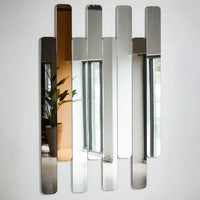 Modern geometric mirror featuring reflective silver and warm copper hues with vertical striped pattern.