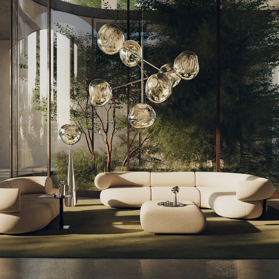 Modern beige sofa set with curved lines, paired with a sleek black coffee table and a vibrant green rug.