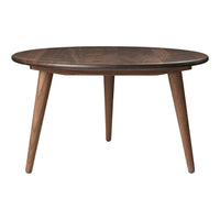 Round wooden table with a rich, dark brown finish and natural wood grain patterns, complemented by tapered legs.