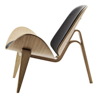 Curved wooden chair in natural wood finish with a contrasting black padded seat. Sleek, modern design and elegant lines.