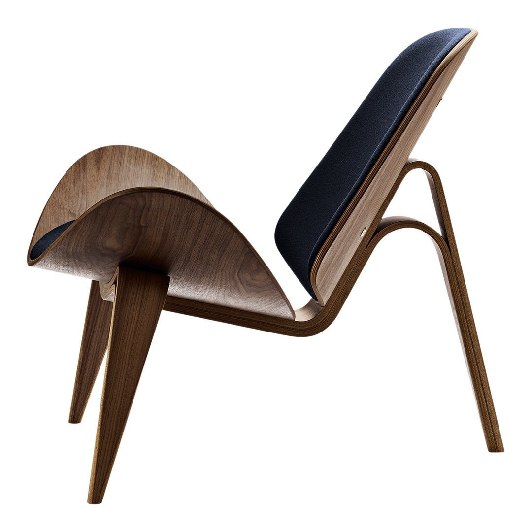 Stylish chair featuring rich walnut wood and a sleek navy cushion, showcasing a modern design with smooth curves.