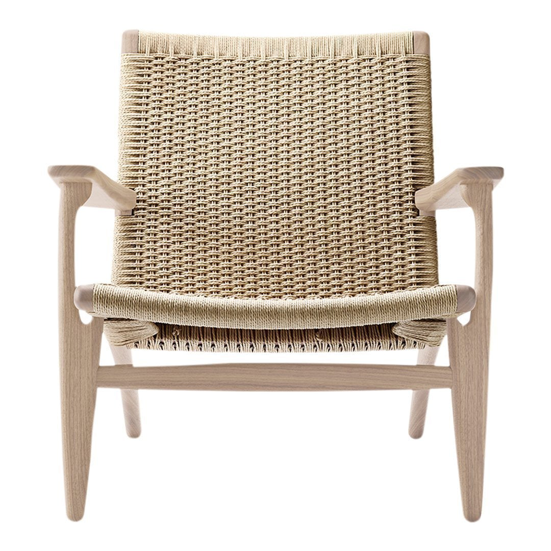 Natural woven chair in beige tones with a light wood frame and simple, clean lines. Perfect for minimalistic decor.