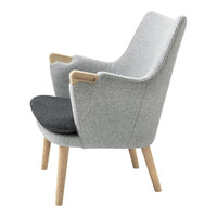 Gray upholstered armchair with contrasting charcoal seat cushion and light wooden legs, featuring a sleek modern design.