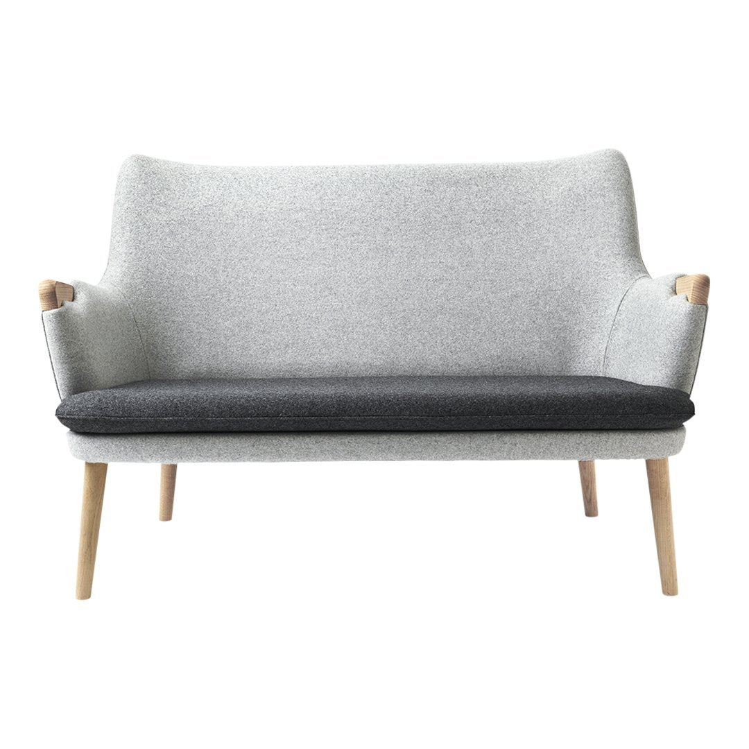 Light gray and dark gray two-tone sofa with wooden legs and a minimalist design. Perfect for modern decor.