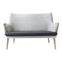 Light gray and dark gray two-tone sofa with wooden legs and a minimalist design. Perfect for modern decor.