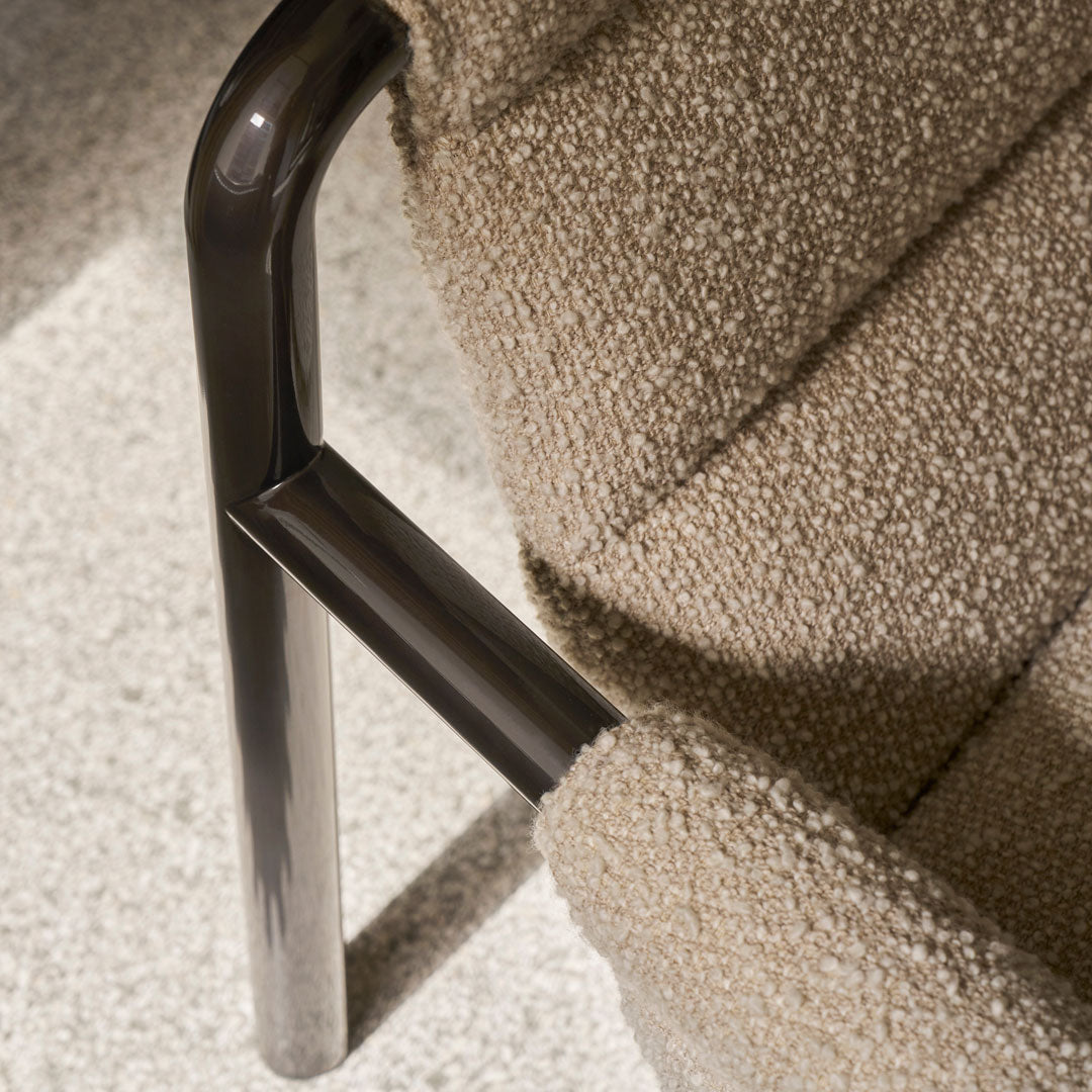 Beige textured fabric upholstery with a sleek black metal frame, adding modern elegance to any space.