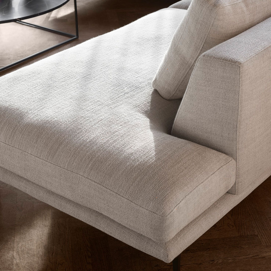 Light grey fabric sofa with a subtle textured pattern, complemented by a smooth, minimalist design.