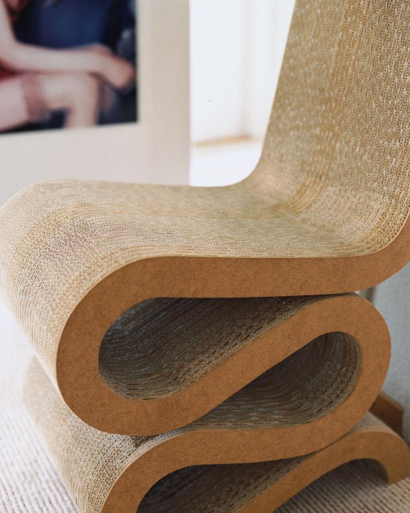 Beige and natural woven pattern chair with smooth, curved design and layered base, perfect for modern decor.