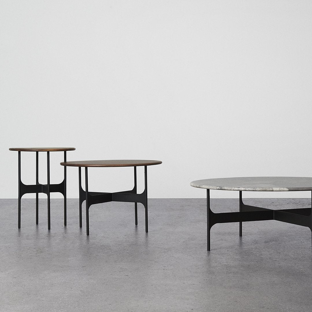 Modern coffee tables featuring a mix of black and natural wood tones with sleek, minimalist designs.