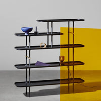 Black metal shelving unit with smooth lines, featuring a pop of yellow graphic background and various decorative colorful items.