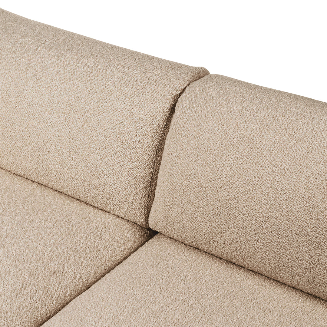 Beige textured fabric close-up with soft, plush surfaces and seamless stitching detail. Ideal for modern upholstery.