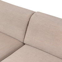 Beige textured fabric upholstery with subtle patterns, ideal for modern living spaces.