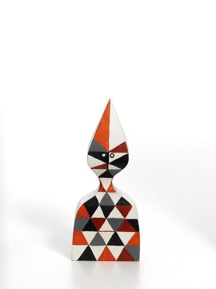 Colorful geometric figure with red, black, and white triangular patterns and a distinctive pointed head.