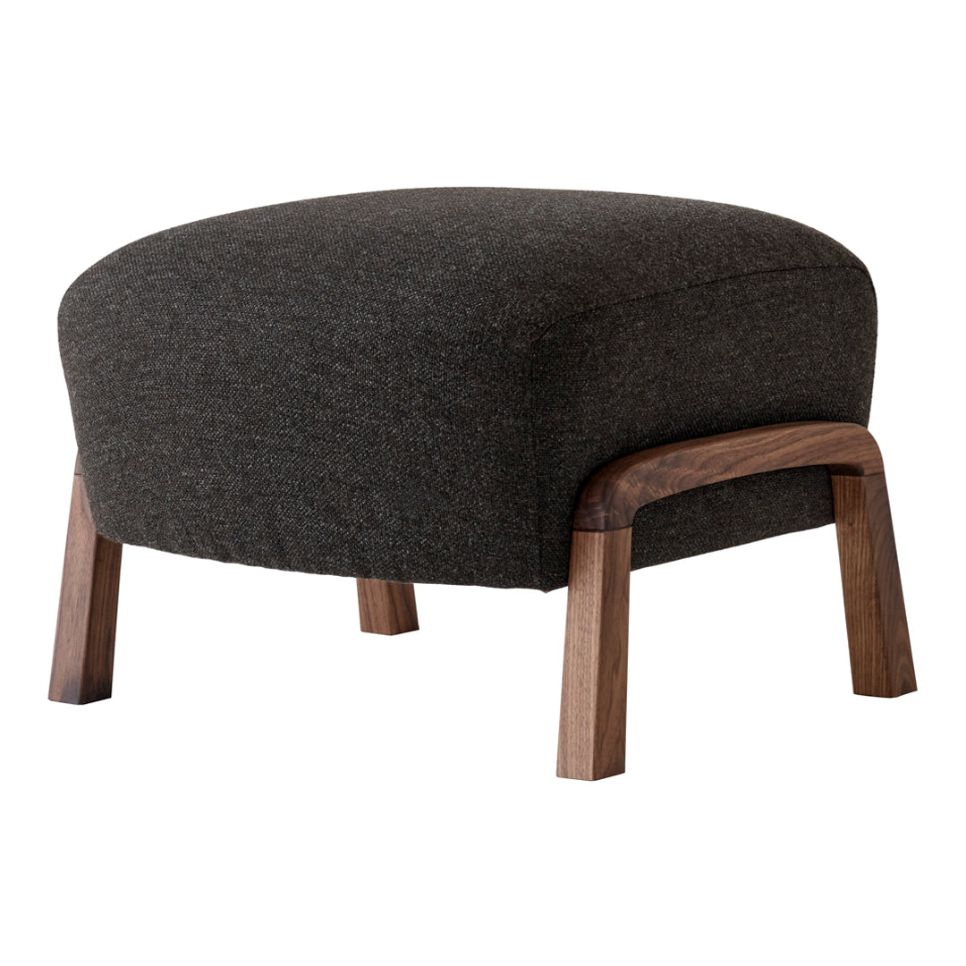 Gray upholstered ottoman with a rounded design and wooden legs, perfect for modern decor.